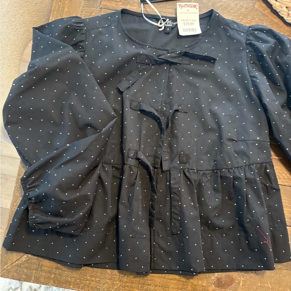 Black peplum top with sparkle accents. NWT